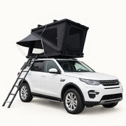 TrailNest Z-frame aluminum hardshell rooftop tent open on a white SUV