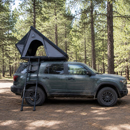 Side view of the TrailNest Wedge 132 rooftop tent mounted level on an off-road SUV