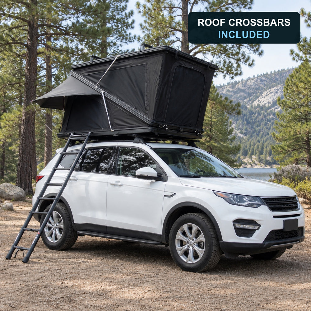 TrailNest Z-frame rooftop tent installed at a lakeside campsite with roof crossbars included