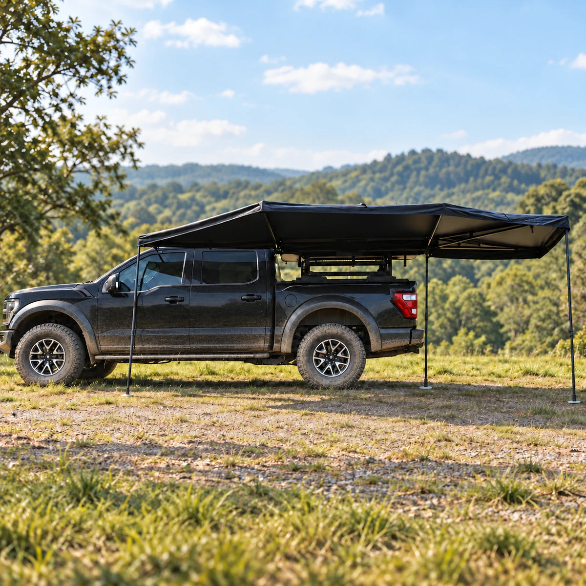 Vehicle-mounted fan awning on a black pickup at an outdoor campsite - illustrative scene based on supplier reference photos