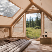 TrailNest inflatable cabin tent interior with queen mattress and warm camping gear