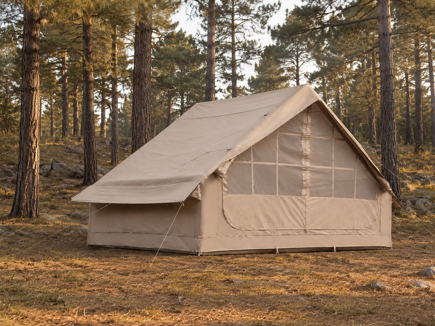 TrailNest Inflatable Cabin Tent fully pitched at a North American pine-forest campsite.
